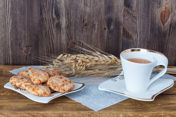 Tea and homemade cookies on a wooden background