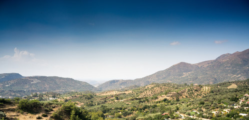 Field and mountain against sky