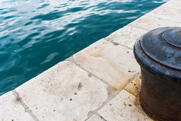 Naklejka premium View of an old rusty marina bollard in the harbor of Split in Dalmatia region in croatia