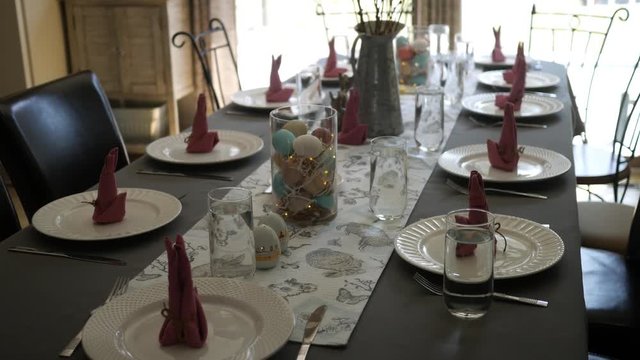 Camera pans down decorative dining room table set for an Easter dinner