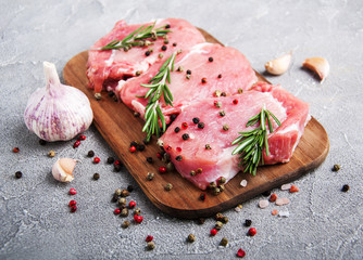 Fresh raw pork chops with spices and herbs