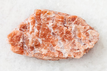 rough pink pegmatite stone on white