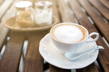 Hot cappuccino one cup on wooden table