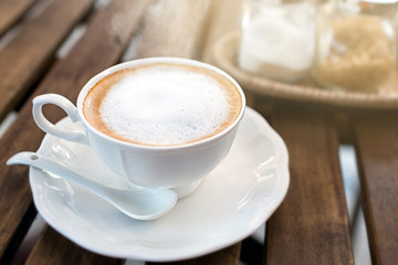 Hot cappuccino one cup on wooden table
