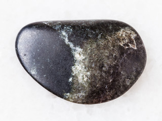tumbled olivinite stone on white