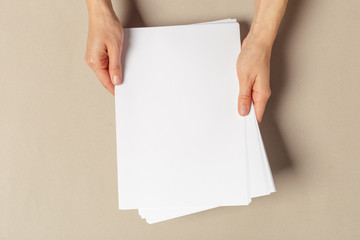 Hand holding papers a4 size