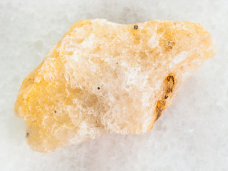 ellow Calcite stone on white marble background