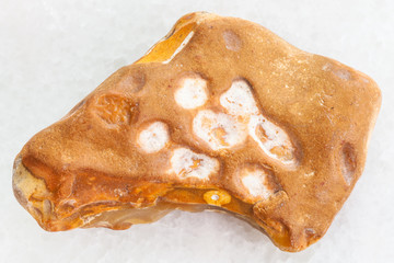 yellow Flint stone on white marble background