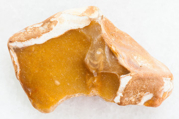 pebble of yellow Flint stone on white marble