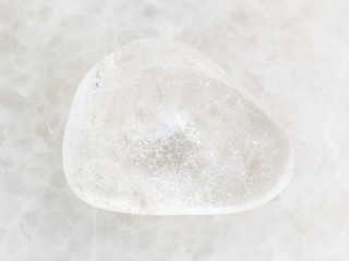 polished Rock-crystal gem stone on white marble