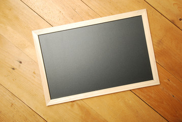 Chalk board top view with wooden background