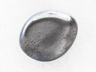 polished hematite gemstone on white marble