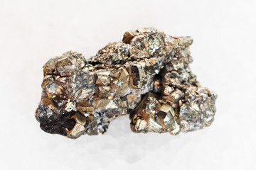 rough pyrite stone on white marble