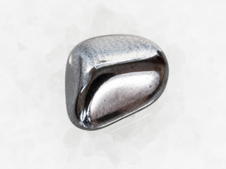 polished hematite gem on white marble © vvoe