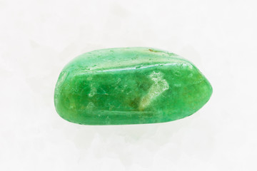pebble of green Agate gemstone on white marble