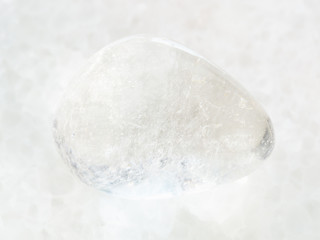 tumbled Rock-crystal gemstone on white marble