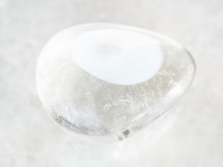 polished Rock-crystal gemstone on white marble