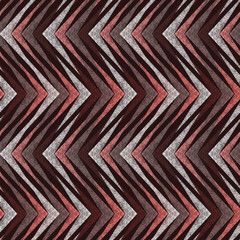 Seamless zigzag white, orange stripes on brown background.