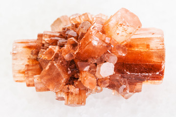 raw crystal of Aragonite gemstone on white marble