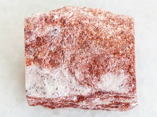 raw pink Aventurine stone on white marble