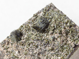 crystals of Epidote on rock close up on white