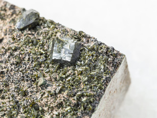 crystals of Epidote on stone close up on white