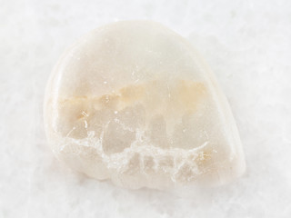 polished Ulexite gemstone on white marble