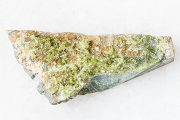 raw crystal of green Vesuvianite gemstone on white