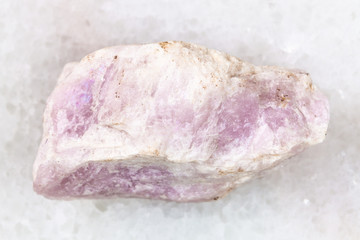 raw Ussingite stone on white marble