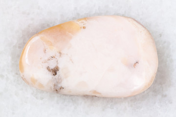 polished pink opal gemstone on white