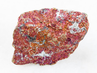 raw red Chalcopyrite stone on white