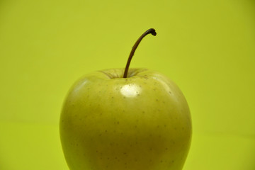  appetizing green apple on a green background