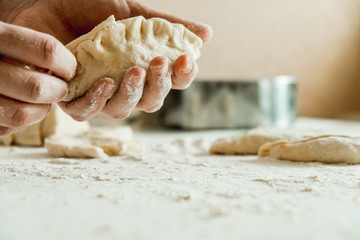 Fototapeta na wymiar homemade cakes of the dough in the women's hands