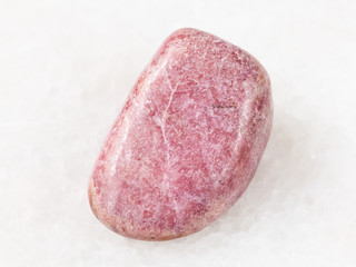 tumbled rhodonite gem on white