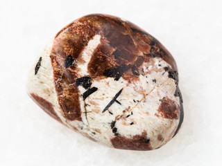 polished Spreustein with microcline stone on white