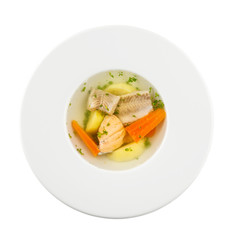fish soup in a white plate. Isolated on a white background