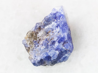 raw crystal of Tanzanite gemstone on white