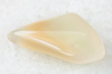 polished yellow moonstone (adularia) gem on white