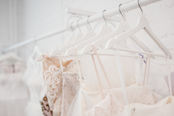 Fototapeta na wymiar White modern wedding dresses in dress store.