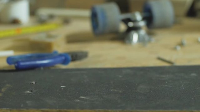 Parts of skateboard on the table, workshop or skatebording store
