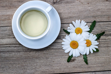 Obraz na płótnie Canvas Cup of chamomile tea on table