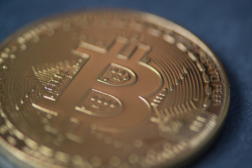 Golden bitcoin closeup, blurred photo. electronic money