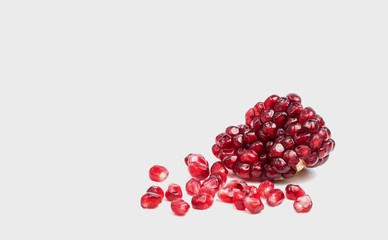 Ripe pomegranate fruit on white background cutout.