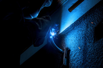 Worker welding the steel part by manual