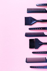 Combs and bleach brushes on pastel colored paper