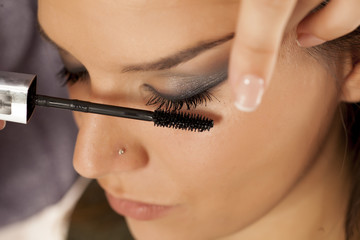 Closeup of makeup artist applying mascara