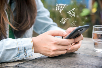 woman in cafe using mobile phone and texting in social networks.