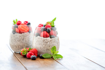 Chia. Superfoods breakfast with Chia seed pudding and  berries in a glass over wooden rustic background. Health concept, omega 3 product..