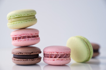 Colorful macaroons stacked on white background