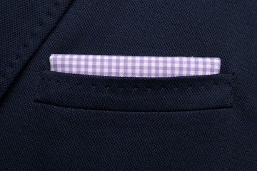 pocket square Purple with white squares - handkerchief in the breast pocket of a man's wool luxury dark blue suit